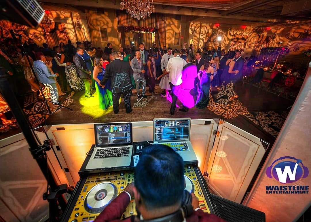 Outdoor night party lit purple around the DJ rig