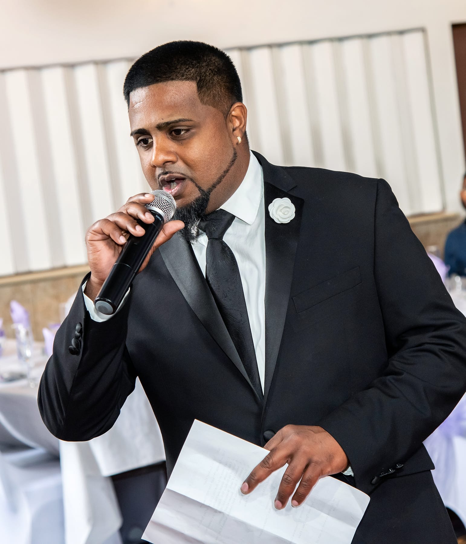MC hosting a wedding reception mic in hand