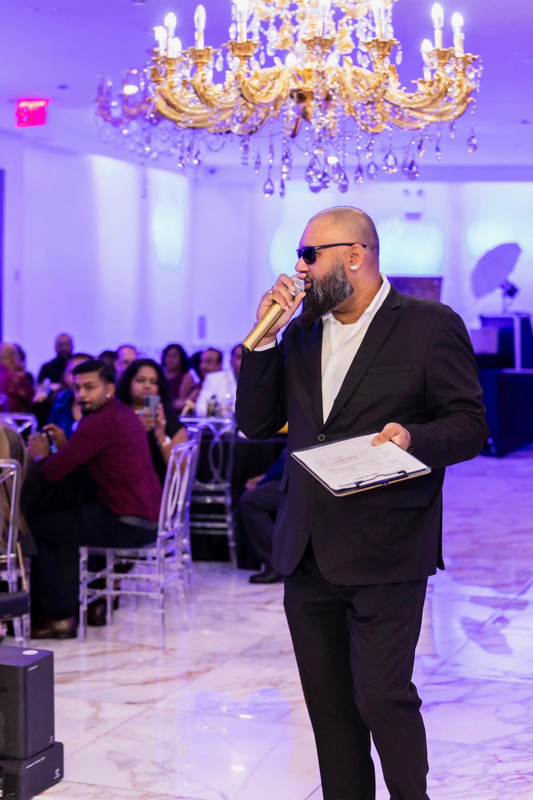 MC working the room mic in hand