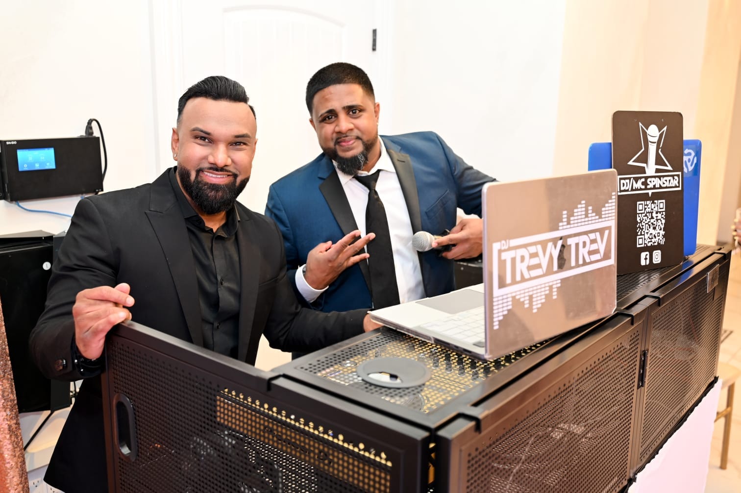 DJ Trevy Trev and DJ/MC Spinstar behind the decks mid-event